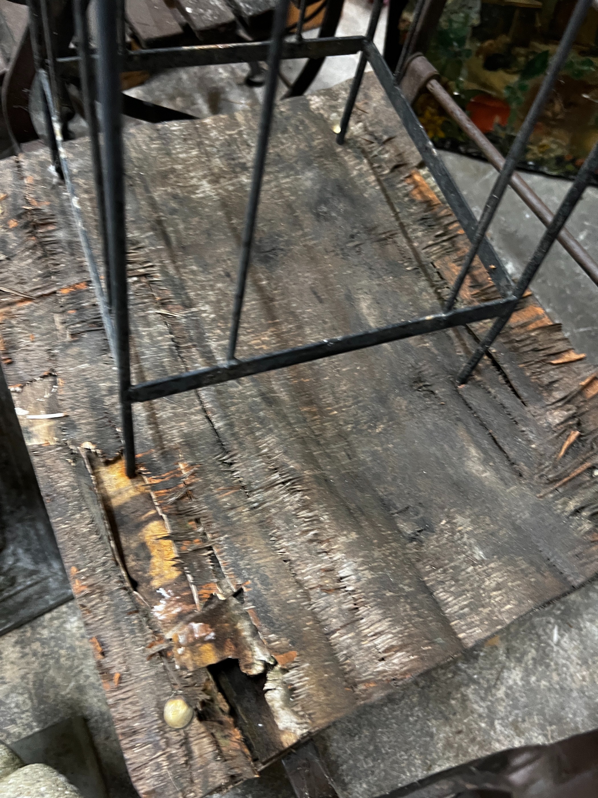 A wrought iron garden growing frame, height 130cm together with three wrought iron folding garden chairs